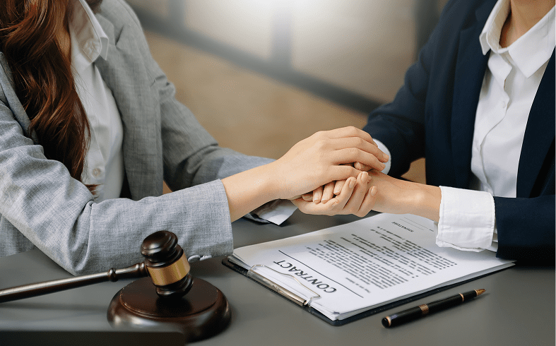 Lawyers comforting each other over contract